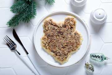 Step-by-step preparation of a festive salad with canned fish and vegetables in the shape of a tiger, step 3 - the second layer with canned fish, top view, horizontal