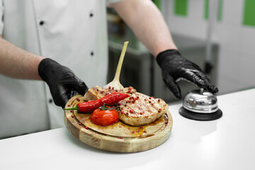 Cook with a ready-made dish with meat and vegetables on a wooden Board