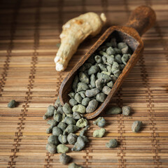 Ginseng tea. Ginseng Oolong tea brew , a teapot and a cup of ginseng oolong tea on a wooden table.  
