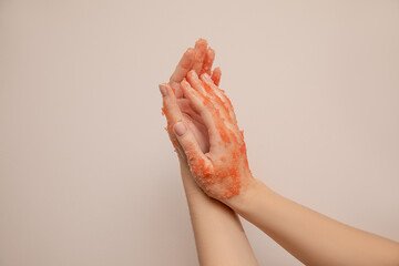 Close-up photo, female hands apply peeling scrub. Skin care. Healthy hand skin concept