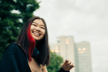 Happy teenage girl with red highlighted hair