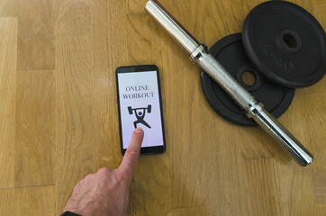 Online workout at home looking at the mobile phone, lifestyle concept
