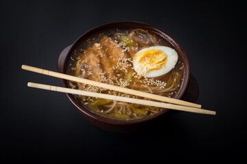 Fresh asian vegetable soup with noodles close up