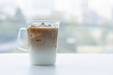 caffe latte in glass on white table.
