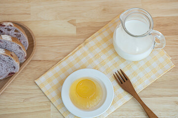 small jug of milk on wooden table.