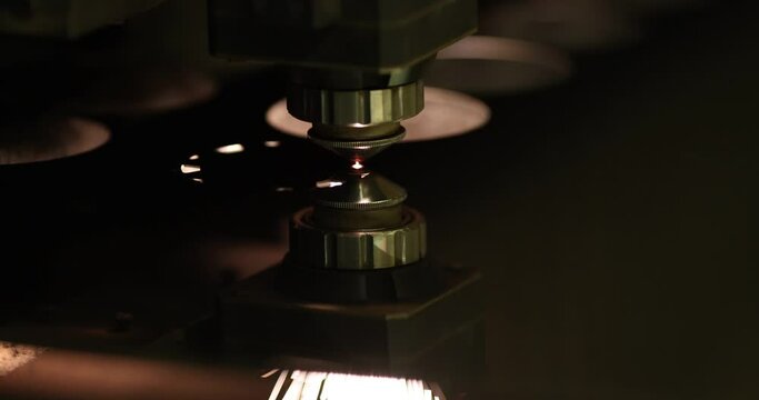 Laser machine cutting circle on iron sheet closeup 4k movie slow motion
