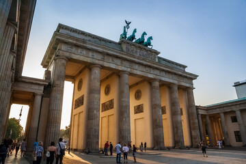 Lovely view of people standing in front of Berlin's most famous monument, the Brandenburg Gate...