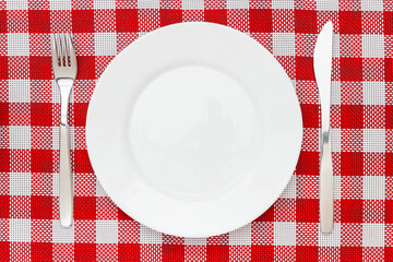 white plate with cutlery on the festive table