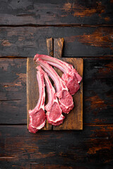 Raw fresh lamb ribs, on old dark  wooden table background, top view flat lay, with copy space for...