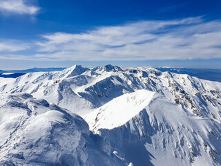 snow covered mountains, viewpoint from Buteanu Peak to Negoiu Peak, Fagaras Mountains, Romania 