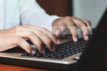 Data Search Technology Search Engine Optimization. man's hands are using a computer notebook to Searching for information.