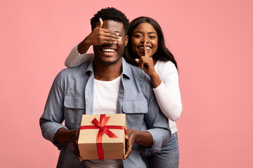 Loving african american woman making surprise for her man