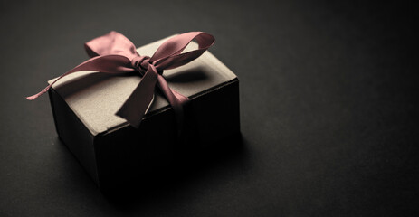 gift box with red ribbon on black background