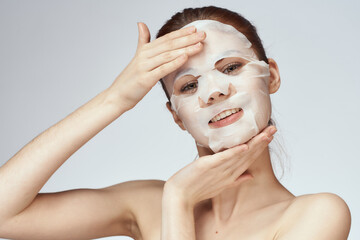 pretty woman naked shoulders face mask close-up skin care