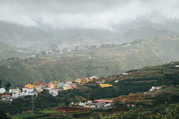 Houses on top of the mountains on a cloudy day