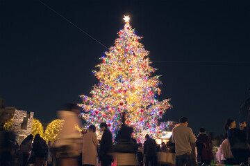 Outdoor Christmas tree and blurred people at Yebisu Garden Place in...