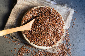 Flax seeds in a wooden bowl.