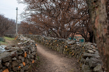 Early spring stone wall road