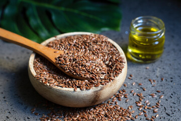 Glass bottle with linseed oil and flax seeds.