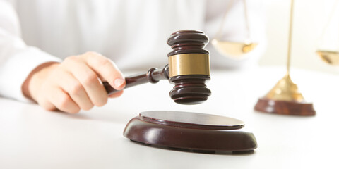 Lawyer working with contract papers and wooden gavel on tabel in courtroom. justice and law...