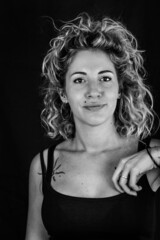 black and white portrait of a beautiful young woman with blonde and curly hair