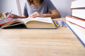 Close up and selective focus shot of woman hands who is writing on tablet screen by using stylus pen at home shows education concept of hard studying by using digital and online technology.