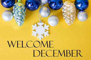 text Hello December on a festive background, Christmas toys on a yellow background