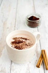 Fotobehang Mug of Hot Chocolate, Ramekin filled with Cocoa Powder and Cinnamon Sticks on Wood © tinasdreamworld