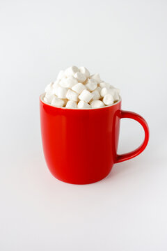 Red Mug filled with Mini Marshmallows isolated on White