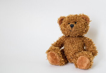 a cute baby soft toy teddy bear sitting isolated on a white background
