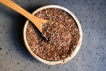 Flax seeds in a wooden bowl.