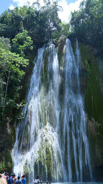 travel stone fall aqua landscape vertical hd photo. The photo of the waterfall was taken in the Dominican Republic in the rainforest. The picture of the jungle with water impresses with its pristine