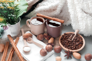 two cups of coffee with macadamia nuts and cinnamon