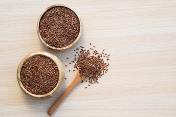 Flax seeds on wooden background