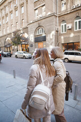 Fototapeta premium Vertical shot of two women enjoying sightseeing in european city center