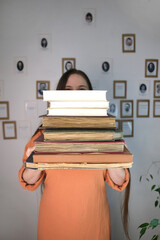 young european woman with long hair holding old thick photo albums, family archive, books, concept...