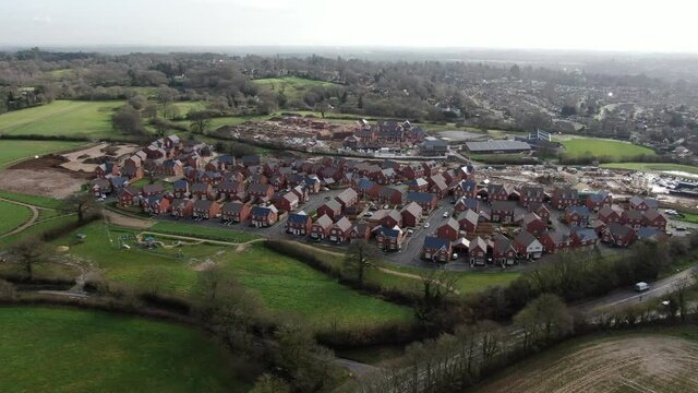 A short full HD aerial video of housing construction on a greenfield site at the edge of the town