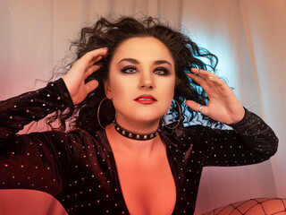 Close-up of a woman with black, curly hair..make-up and style 90s. Photograph with colored light
