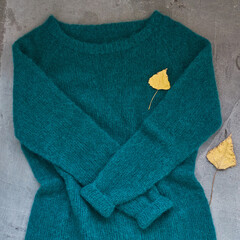 Green knitted sweater handmade isolated gray backround leaf