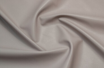 gray artificial leather with waves and folds on PVC base