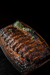 grilled and barbecue ribs pork on dark wooden background