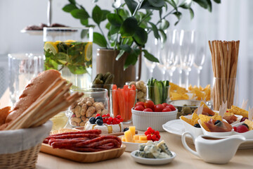 Variety of snacks on wooden table in buffet style indoors