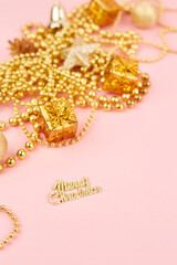 Golden christmas decorations on pink background. Christmas New year or party banner