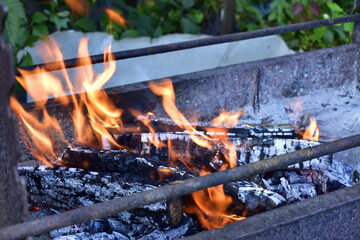 view of the burning firewood in the barbecue grill