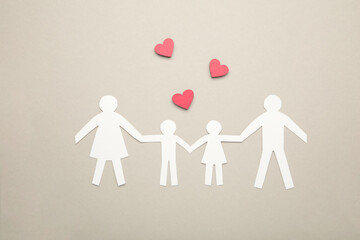 Happy paper family with hearts on grey background. Family day