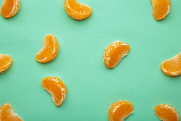 Fresh mandarin segments on the mint background.