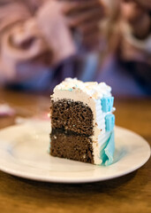Piece chocolate cake with topped whipping cream on white dish