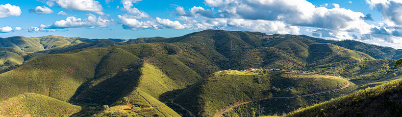 panoramic view of the algarve's lost places, low cut, green hills and clouds