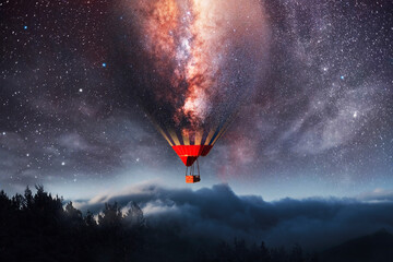 Fantasy night scene, the balloon stars flying in the sky above beautiful clouds and mountains.