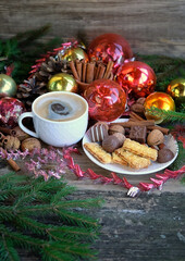 coffee cup, sweet treats, chocolate, Christmas winter decor on wooden table. Christmas and New Year Holidays background. cozy home festive winter seasonal composition